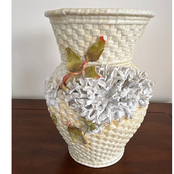 Vintage Chinese porcelain amphora-style vase decorative floral on a textured.